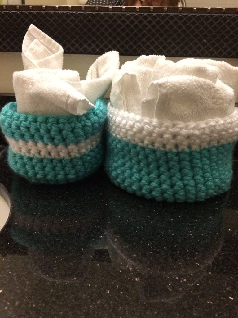 crochet baskets holding towels