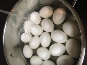 Running cool water on eggs