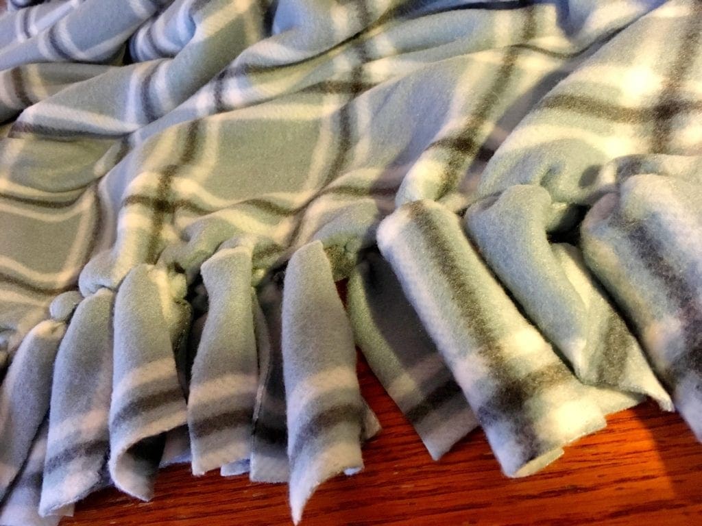 Tying Fringe on Blanket