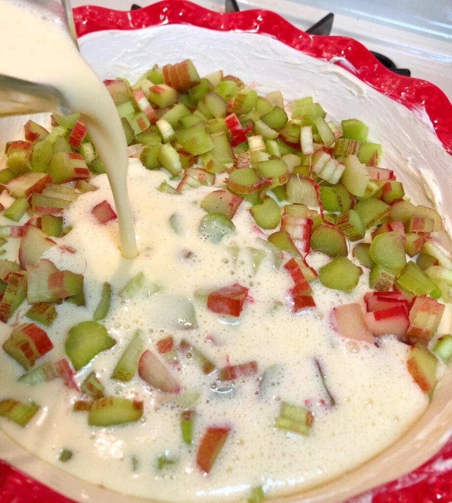 Pouring custard over rhubarb