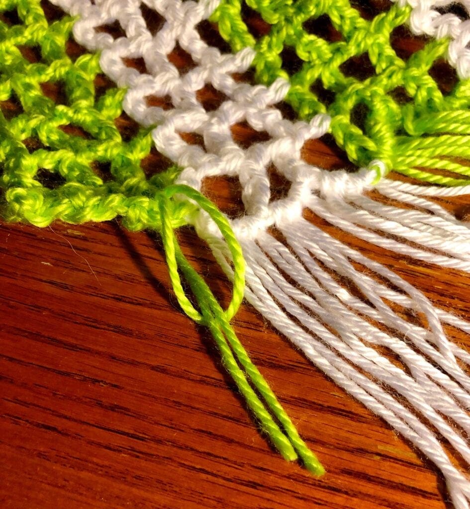 bringing ends of the yarn through the loop.