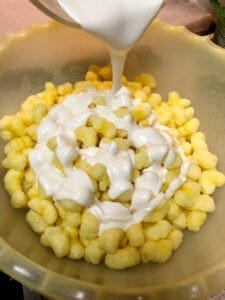 Pouring White Chocolate Over Puff Corn