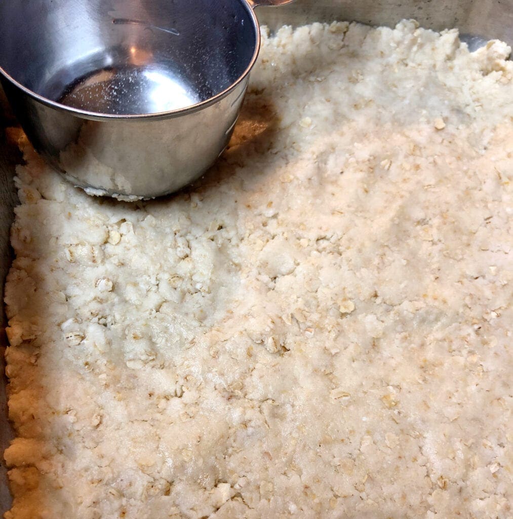 Patting Bottom Layer of Cake Mix Bars into Pan