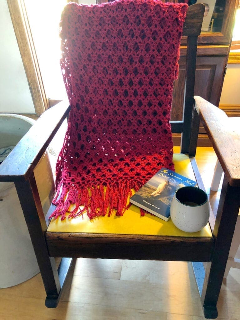 Simply Sophisticated Scarlet Crochet Throw Over the Back of a Rocking Chair a Good Book and Coffee