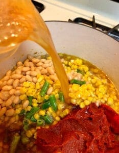 Adding ham broth to the soup