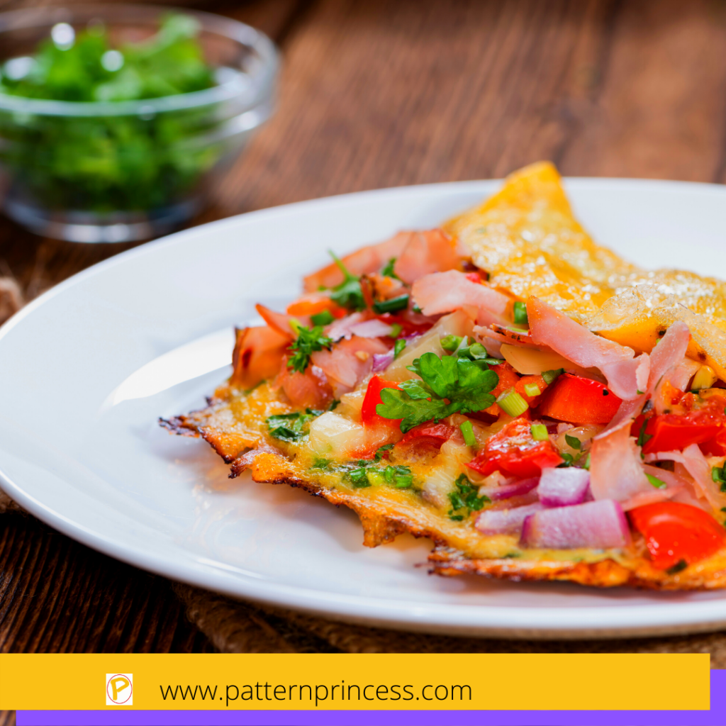 Omelette with fresh ingredients like tomatoes, onions, and basil