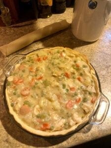 Filling the Pre-Baked Pie Crust with the Classic Chicken Pot Pie Mixture
