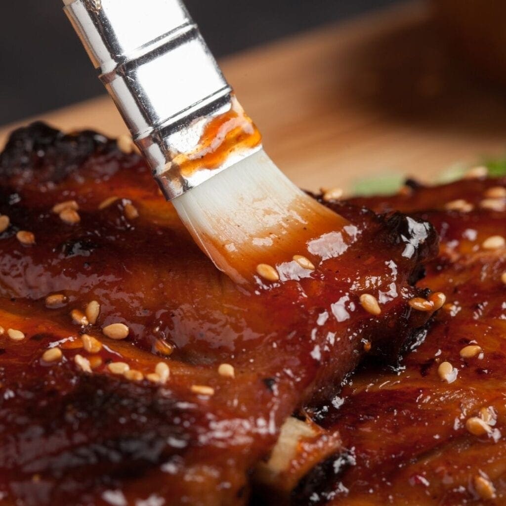 Brushing BBQ Sauce on Ribs