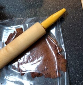 Rolling Out Dough Between Pieces of Plastic