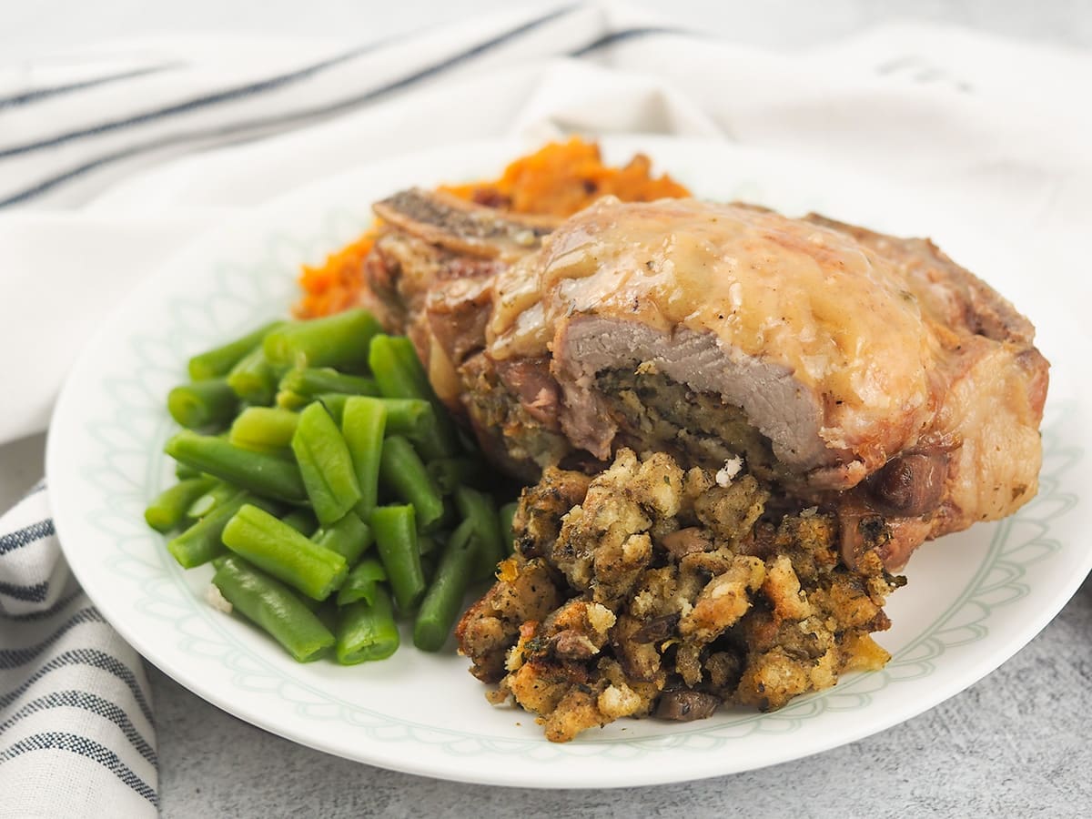 stuffed-pork-chops-on-plate-with-green-beans