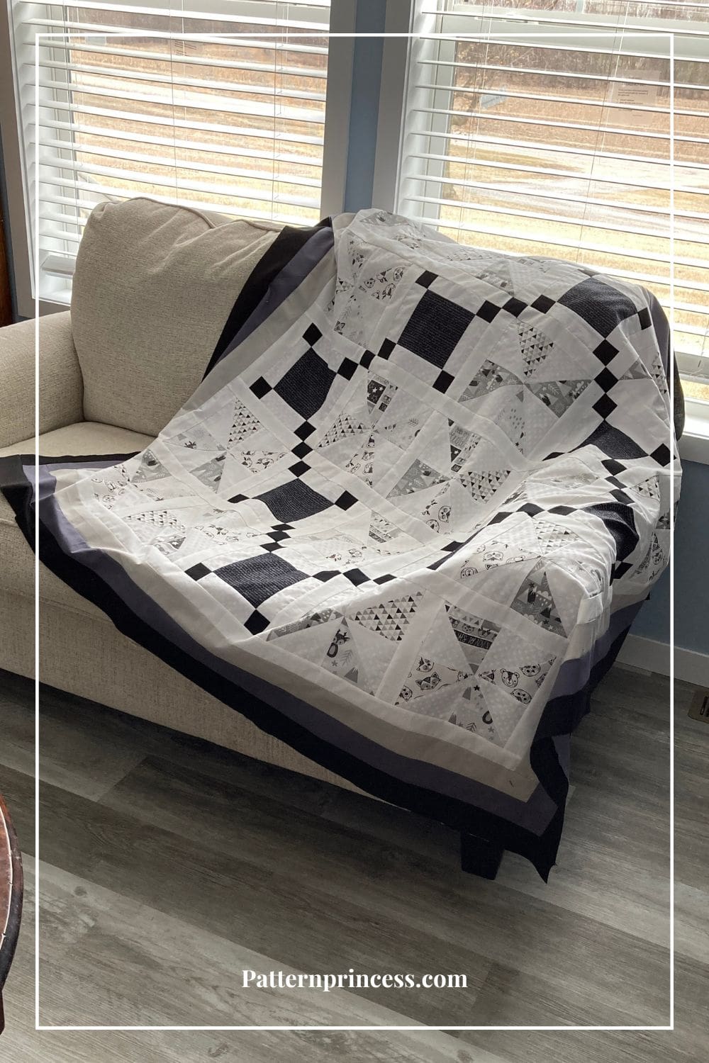 Grey and White Toddler Quilt Displayed on Sofa