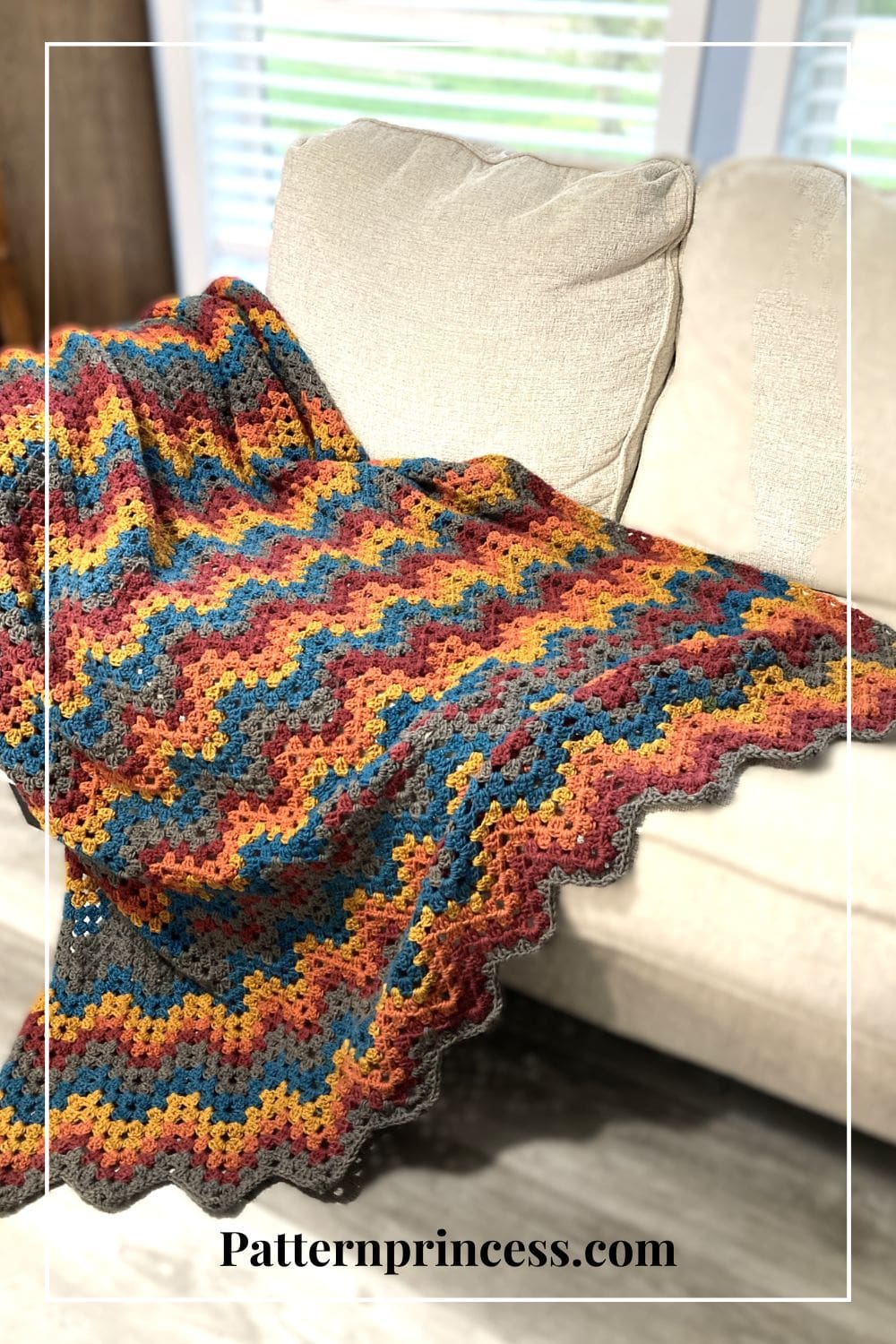 Zigzag crochet blanket in bright colors on sofa