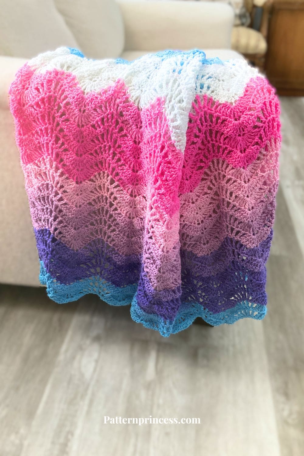 lacy baby blanket draped over sofa