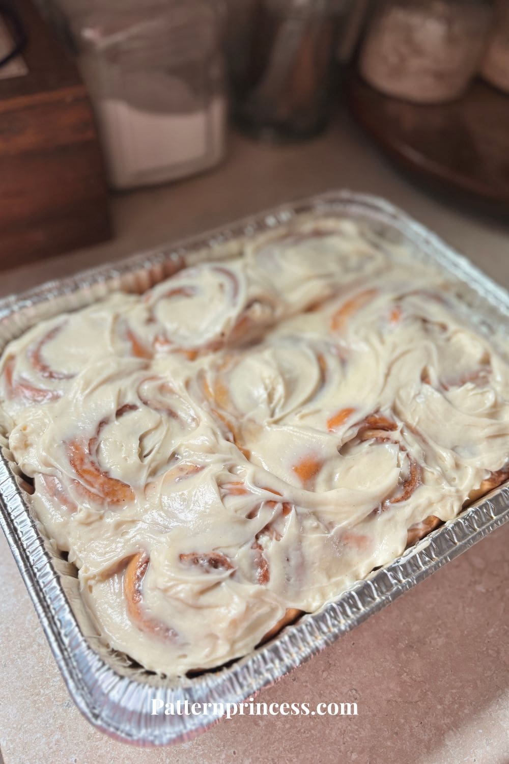 Pan full of cinnamon rolls with frosting